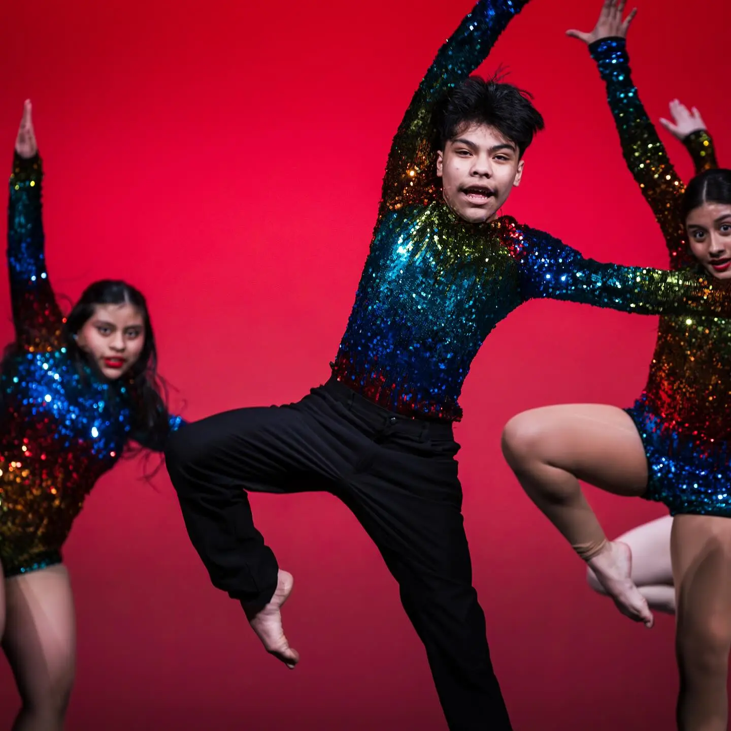 An ensemble in sequins under stage light
