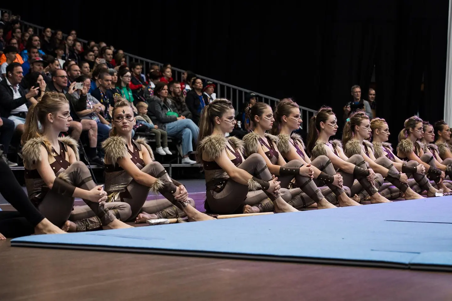 A packed hall watching a group performance at World Gymnaestrada Amsterdam 2023